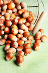 Hazelnuts in basket on wooden background