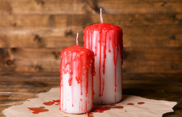 Bloody candles for Halloween holiday, on wooden background