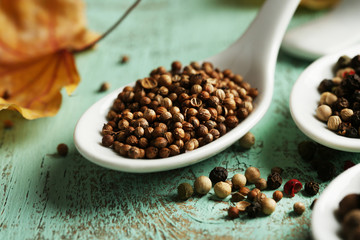 Different spices in spoons with yellow leaves