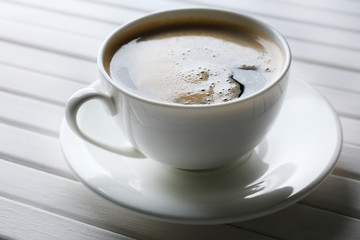 Cup of coffee on wooden table