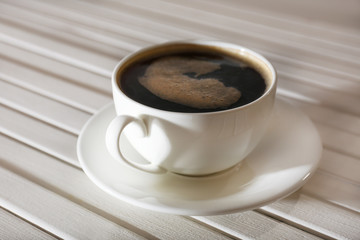 Cup of coffee on wooden table