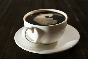 Cup of coffee on wooden table