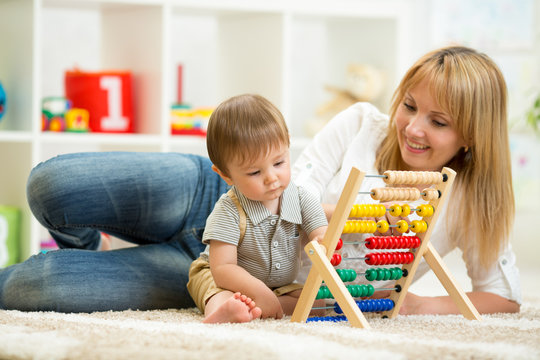kid and mother playing with abacus