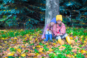 Adorable little girls at beautiful autumn day outdoors