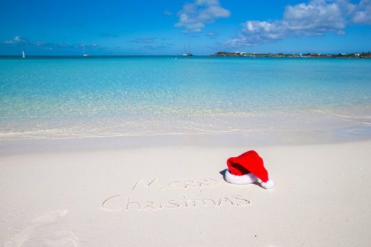 Merry Christmas written on tropical beach white sand with xmas