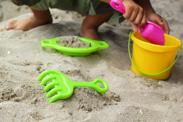Children's beach toys on sand
