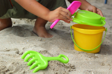 Children's beach toys on sand