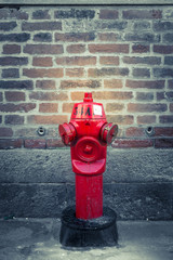 Old red hydrant in the dark lane