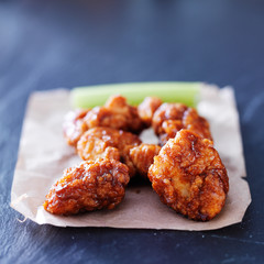 boneless barbecue chicken wings on slate table