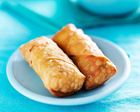 Chinese Egg Rolls On Vibrant Blue Table Setting