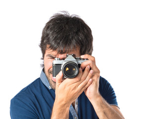 Fototapeta premium Man photographing over white background