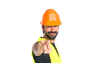 Workman pointing to the front over white background