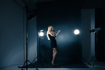 Beautiful woman posing at studio in light flashes