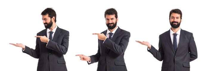 Businessman pointing to the lateral over white background