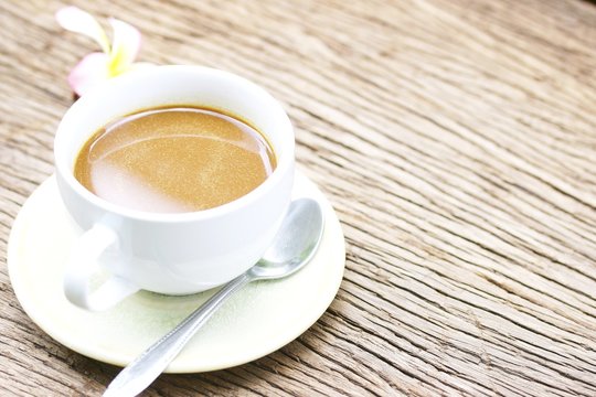 coffee in white cup on wooden table