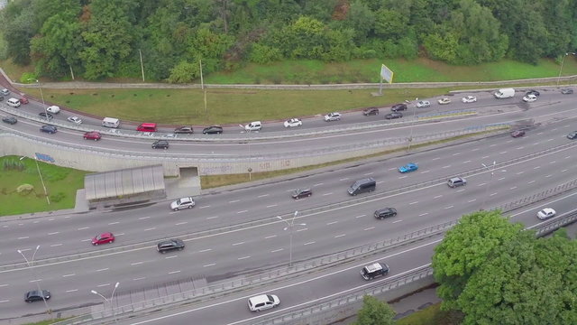 Cars driving slowly down the city road, traffic jam aerial