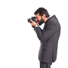 Businessman photographing over white background