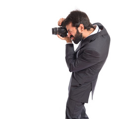 Businessman photographing over white background