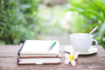 Notebook  and coffee on wooden table