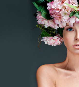 fashion model with large hairstyle and flowers in her hair.
