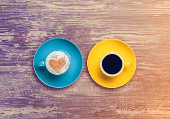 two cup of coffee on a table.