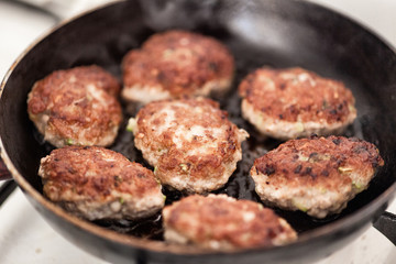 Fried meatballs in frying pan