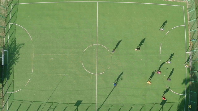 Soccer (football) players on field, active rest. View from air
