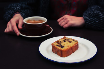 Young woman having coffee and cake
