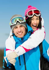 Portrait of happy couple of skiers have fun