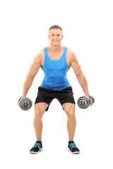 Young athlete exercising with two barbells