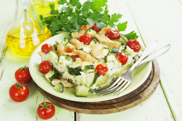 Zucchini baked with chicken, cherry tomatoes and herbs