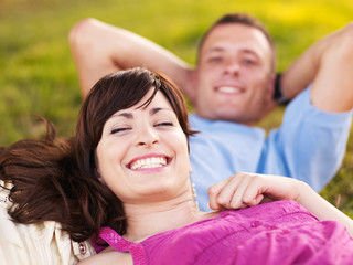 Couple laying on the grass