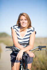 Fototapeta na wymiar girl sitting on bike at the field