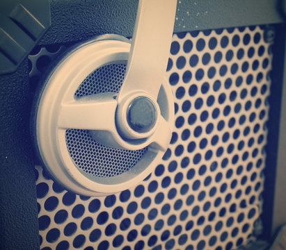 close up of a guitar amplifier grill with a headset on it