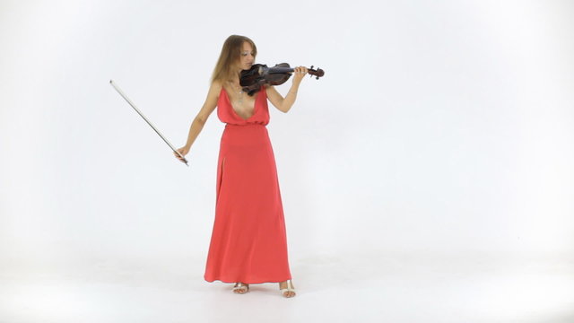 Young violinist plays in a long dress on her a musical