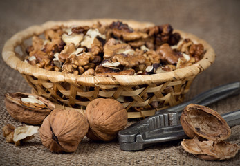 Walnuts in burlap bag on white