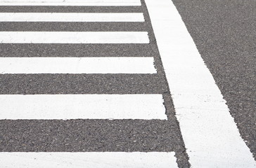 Obraz premium close - up zebra crosswalk on the road