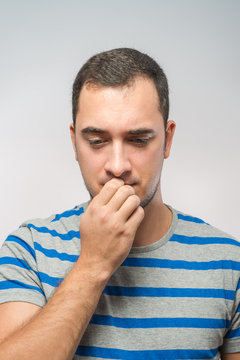 stressed mid adult man biting fingernails