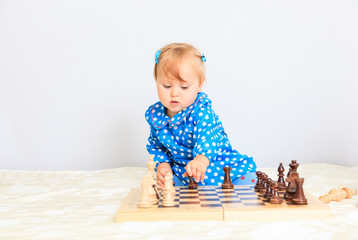 cute little girl playing chess