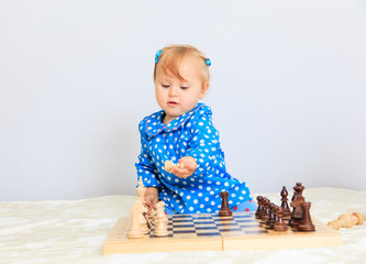 cute little girl playing chess