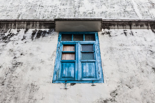 Blue wooden window and grunge wall