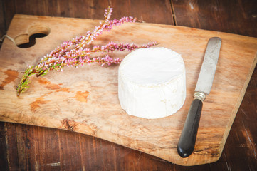 Smelly blue cheese on a wooden rustic table with knife