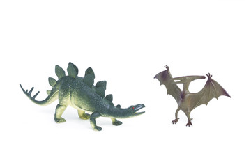 Pterosaur and Stegosaurus dinosaur toy on white background