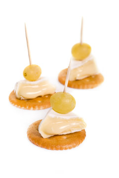 Canape with Brie Cheese and Grape isolated on white