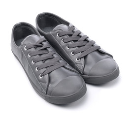 Grey sneakers on a white background - obrazy, fototapety, plakaty
