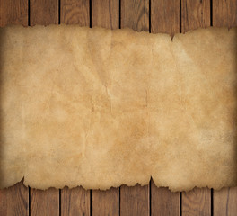 Old torn paper on wooden background
