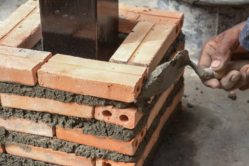 Construction mason worker with trowel and cement mortar