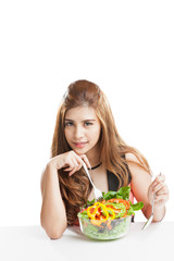 Young woman brunette present and eating salad