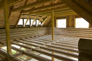 Unfinished attic floor of wooden cabin - obrazy, fototapety, plakaty