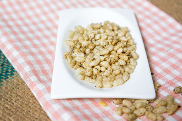 puffed rice cereal on a plate isolated